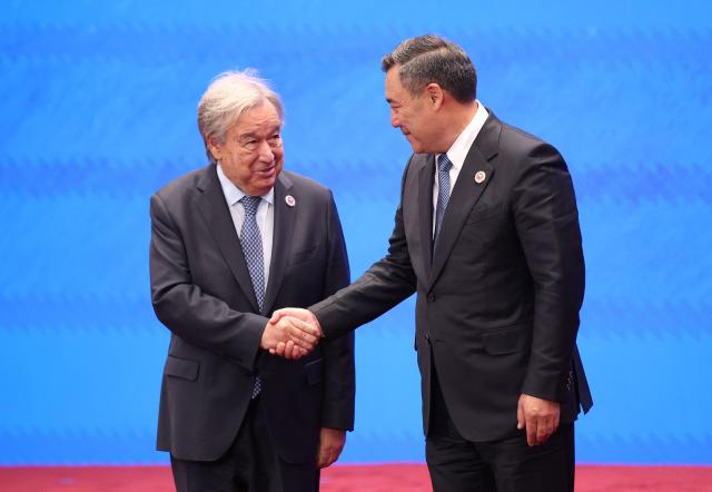 In this pool photograph distributed by the Russian state agency Sputnik, Kyrgyzstan's President Sadyr Japarov welcomes United Nations Secretary-General Antonio Guterres prior to the Shanghai Cooperation Organisation (SCO) summit in Bishkek on September 1, 2026. (Photo by Peter KOVALEV / POOL / AFP)