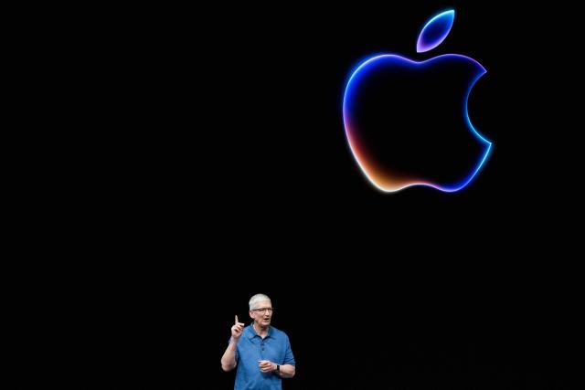 (FILES) Apple CEO Tim Cook speaks during Apple's annual Worldwide Developers Conference (WDC) in Cupertino, California on June 10, 2024. Apple's chief executive Tim Cook hands over the company's reins to it's vice president of hardware engineering John Ternus on September 1, 2026. Cook spent nearly three decades at Apple, which he has led as CEO since 2011. (Photo by Nic Coury / AFP)