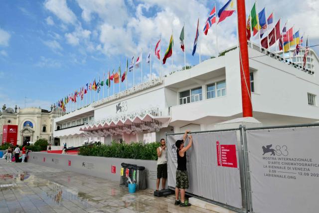 Workers adjust fences near the red carpet on the eve of the 83Rd Venice Film Festival at Venice Lido on September 1, 2026. (Photo by Stefano RELLANDINI / AFP)