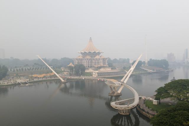 An aerial view shows haze shrouding the area around the Sarawak Legislative Assembly building (C) in Kuching, the capital city of Sarawak state on the island of Borneo on September 1, 2026. Air quality in Malaysia's Sarawak state deteriorated further on September 1 as smoke from Indonesian forest fires drove up respiratory complaints and sent residents scrambling for protective masks. (Photo by AFP)