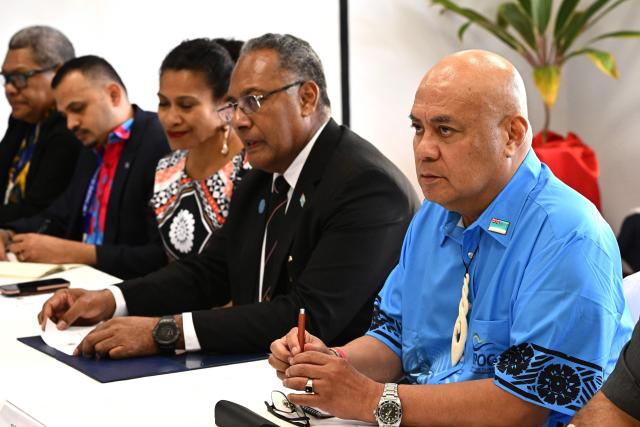 Tuvalu’s Prime Minister Feleti Teo (R) and Fiji’s Minister for Foreign Affairs Sakiasi Ditoka (2nd R) hold talks with Australian Prime Minister Anthony Albanese at a trilateral meeting during the 55th Pacific Islands Forum Leaders Meeting in Koror on September 1, 2026. (Photo by SAEED KHAN / AFP)