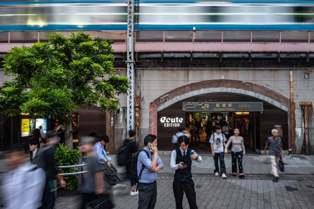 People gather in front of Shimbashi metro station in Tokyo on September 1, 2026. (Photo by Philip FONG / AFP)