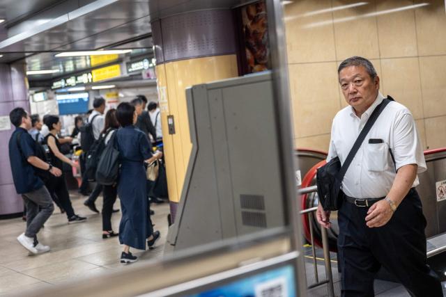 People walk through Shimbashi metro station in Tokyo on September 1, 2026. (Photo by Philip FONG / AFP)