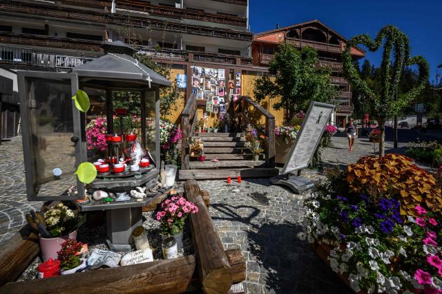 This photograph shows portraits displayed at a makeshift memorial for the victims of the devastating New Year's fire on the door of the Constellation bar, in Crans-Montana, Switzerland, on September 1, 2026. A total of 41 people were killed in the tragedy -- mostly teenagers -- while another 115 were injured. (Photo by Fabrice COFFRINI / AFP)