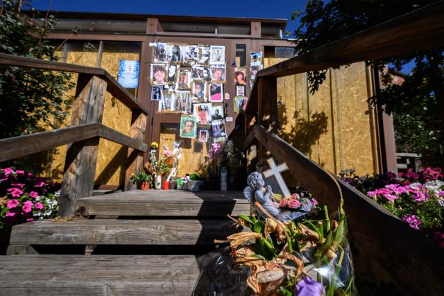 This photograph shows portraits displayed at a makeshift memorial for the victims of the devastating New Year's fire on the door of the Constellation bar, in Crans-Montana, Switzerland, on September 1, 2026. A total of 41 people were killed in the tragedy -- mostly teenagers -- while another 115 were injured. (Photo by Fabrice COFFRINI / AFP)