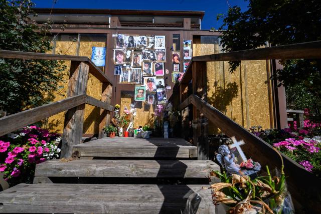 This photograph shows portraits displayed at a makeshift memorial for the victims of the devastating New Year's fire on the door of the Constellation bar, in Crans-Montana, Switzerland, on September 1, 2026. A total of 41 people were killed in the tragedy -- mostly teenagers -- while another 115 were injured. (Photo by Fabrice COFFRINI / AFP)