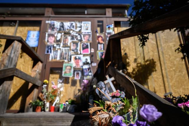 This photograph shows portraits displayed at a makeshift memorial for the victims of the devastating New Year's fire on the door of the Constellation bar, in Crans-Montana, Switzerland, on September 1, 2026. A total of 41 people were killed in the tragedy -- mostly teenagers -- while another 115 were injured. (Photo by Fabrice COFFRINI / AFP)