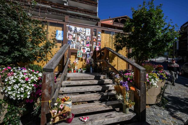 This photograph shows a makeshift memorial for the victims of the devastating New Year's fire in front of the Constellation bar, in Crans-Montana, Switzerland, on September 1, 2026. A total of 41 people were killed in the tragedy -- mostly teenagers -- while another 115 were injured. (Photo by Fabrice COFFRINI / AFP)