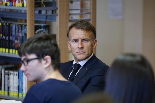 France's President Emmanuel Macron looks on during a visit of the Chaptal High School on the first day of the new academic year in Mende, southern France on September 1, 2026. Some 11.6 million primary, middle and secondary school pupils are returning to school on September 1, 2026, with headteachers' preparations having been disrupted by the fallout from a cyberattack targeting the French Ministry of Education this summer. Among the main changes this year are a ban on mobile phones in sixth-form colleges and the distribution to all pupils, from the final year of nursery school to the final year of sixth form, of a questionnaire on gender-based and sexual violence. (Photo by Guillaume HORCAJUELO / POOL / AFP)