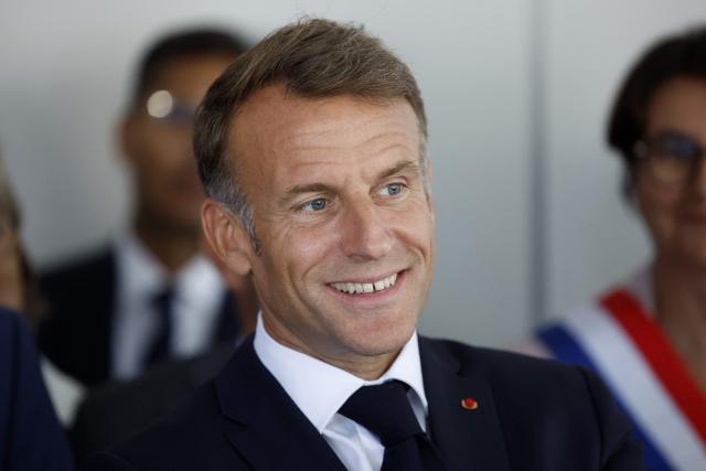 France's President Emmanuel Macron reacts during a visit of the Chaptal High School on the first day of the new academic year in Mende, southern France on September 1, 2026. Some 11.6 million primary, middle and secondary school pupils are returning to school on September 1, 2026, with headteachers' preparations having been disrupted by the fallout from a cyberattack targeting the French Ministry of Education this summer. Among the main changes this year are a ban on mobile phones in sixth-form colleges and the distribution to all pupils, from the final year of nursery school to the final year of sixth form, of a questionnaire on gender-based and sexual violence. (Photo by Guillaume HORCAJUELO / POOL / AFP)
