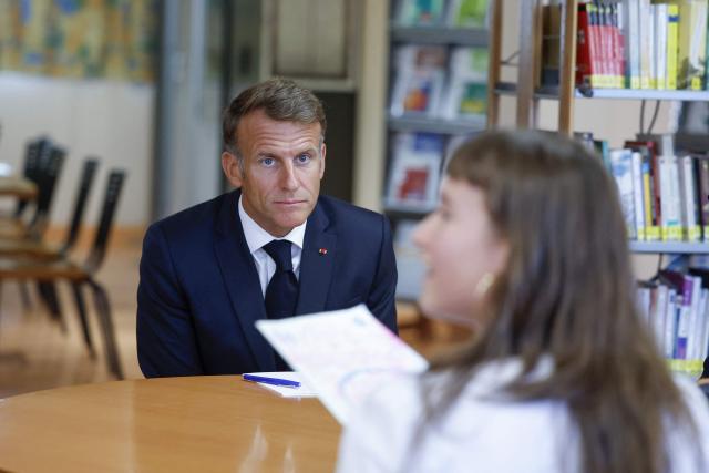 France's President Emmanuel Macron looks on during a visit of the Chaptal High School on the first day of the new academic year in Mende, southern France on September 1, 2026. Some 11.6 million primary, middle and secondary school pupils are returning to school on September 1, 2026, with headteachers' preparations having been disrupted by the fallout from a cyberattack targeting the French Ministry of Education this summer. Among the main changes this year are a ban on mobile phones in sixth-form colleges and the distribution to all pupils, from the final year of nursery school to the final year of sixth form, of a questionnaire on gender-based and sexual violence. (Photo by Guillaume HORCAJUELO / POOL / AFP)