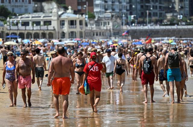 (FILES) A lifeguard walks on La Concha beach in the Spanish Basque city of San Sebastian, on June 21, 2026, first day of the first official heatwave of this summer. Spain registered more than 5,000 heat-related deaths from June to August, data from a public health institute showed on August 31, 2026, a record since the start of its statistics in 2015. (Photo by ANDER GILLENEA / AFP)