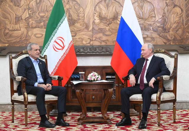 In this pool photograph distributed by the Russian state agency Sputnik, Russia's President Vladimir Putin and Iran's President Masoud Pezeshkian hold a meeting on the sidelines of the Shanghai Cooperation Organisation (SCO) summit in Bishkek on September 1, 2026. (Photo by Kristina Solovyova / POOL / AFP)