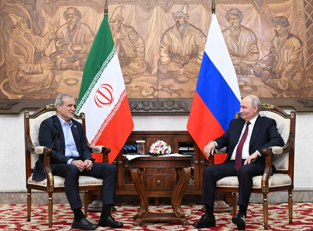 In this pool photograph distributed by the Russian state agency Sputnik, Russia's President Vladimir Putin and Iran's President Masoud Pezeshkian hold a meeting on the sidelines of the Shanghai Cooperation Organisation (SCO) summit in Bishkek on September 1, 2026. (Photo by Kristina Solovyova / POOL / AFP)