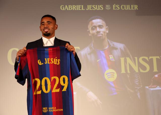 Brazilian forward Gabriel Jesus poses with his jersey during his official presentation as FC Barcelona's new football player on September 1, 2026 in Barcelona. Barcelona signed Brazilian forward Gabriel Jesus from Arsenal on a deal until 2029. (Photo by Lluis GENE / AFP)