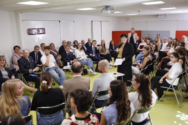 France's President Emmanuel Macron (C) and France's Minister of Education Edouard Geffray (C-R) speak with students during a visit to the INSPE University on the first day of the new academic year in Mende, southern France on September 1, 2026. Some 11.6 million primary, middle and secondary school pupils are returning to school on September 1, 2026, with headteachers' preparations having been disrupted by the fallout from a cyberattack targeting the French Ministry of Education this summer. Among the main changes this year are a ban on mobile phones in sixth-form colleges and the distribution to all pupils, from the final year of nursery school to the final year of sixth form, of a questionnaire on gender-based and sexual violence. (Photo by Guillaume HORCAJUELO / POOL / AFP)