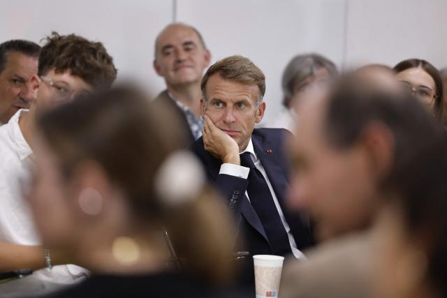 France's President Emmanuel Macron (C) speaks with with students during a visit to the INSPE University on the first day of the new academic year in Mende, southern France on September 1, 2026. Some 11.6 million primary, middle and secondary school pupils are returning to school on September 1, 2026, with headteachers' preparations having been disrupted by the fallout from a cyberattack targeting the French Ministry of Education this summer. Among the main changes this year are a ban on mobile phones in sixth-form colleges and the distribution to all pupils, from the final year of nursery school to the final year of sixth form, of a questionnaire on gender-based and sexual violence. (Photo by Guillaume HORCAJUELO / POOL / AFP)