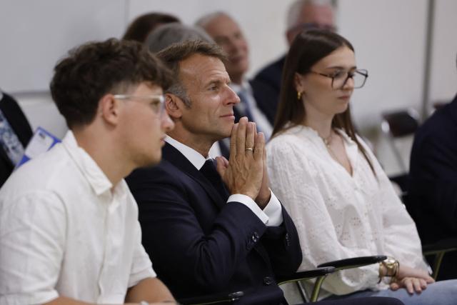 France's President Emmanuel Macron (C) speaks with with students during a visit to the INSPE University on the first day of the new academic year in Mende, southern France on September 1, 2026. Some 11.6 million primary, middle and secondary school pupils are returning to school on September 1, 2026, with headteachers' preparations having been disrupted by the fallout from a cyberattack targeting the French Ministry of Education this summer. Among the main changes this year are a ban on mobile phones in sixth-form colleges and the distribution to all pupils, from the final year of nursery school to the final year of sixth form, of a questionnaire on gender-based and sexual violence. (Photo by Guillaume HORCAJUELO / POOL / AFP)