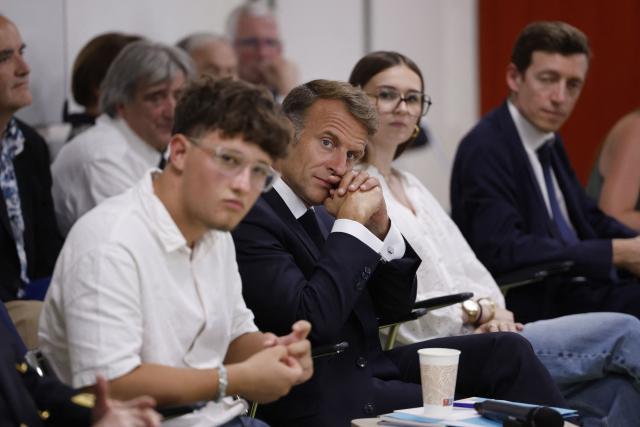 France's President Emmanuel Macron (C) and France's Minister of Education Edouard Geffray (R) speak with students during a visit to the INSPE University on the first day of the new academic year in Mende, southern France on September 1, 2026. Some 11.6 million primary, middle and secondary school pupils are returning to school on September 1, 2026, with headteachers' preparations having been disrupted by the fallout from a cyberattack targeting the French Ministry of Education this summer. Among the main changes this year are a ban on mobile phones in sixth-form colleges and the distribution to all pupils, from the final year of nursery school to the final year of sixth form, of a questionnaire on gender-based and sexual violence. (Photo by Guillaume HORCAJUELO / POOL / AFP)