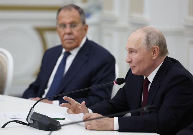 In this pool photograph distributed by the Russian state agency Sputnik, Russia's President Vladimir Putin, accompanied by Foreign Minister Sergei Lavrov, speaks during a meeting with Tajikistan's President on the sidelines of the Shanghai Cooperation Organisation (SCO) summit in Bishkek on September 1, 2026. (Photo by Vyacheslav PROKOFYEV / POOL / AFP)