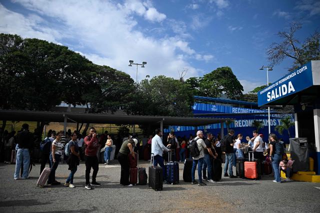 Passengers check in during the reopening of Simon Bolivar International Airport, which was damaged by twin earthquakes in June, in Maiquetia, Venezuela, on September 1, 2026. (Photo by Federico PARRA / AFP)
