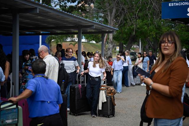 Passengers check in during the reopening of Simon Bolivar International Airport, which was damaged by twin earthquakes in June, in Maiquetia, Venezuela, on September 1, 2026. (Photo by Federico PARRA / AFP)