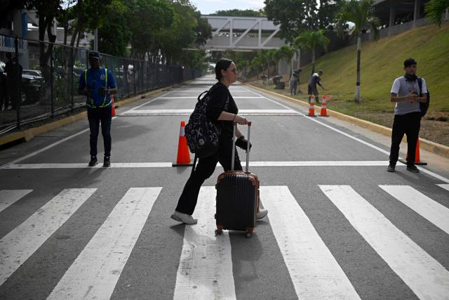 A passenger arrives to check in during the reopening of Simon Bolivar International Airport, which was damaged by twin earthquakes in June, in Maiquetia, Venezuela, on September 1, 2026. (Photo by Federico PARRA / AFP)