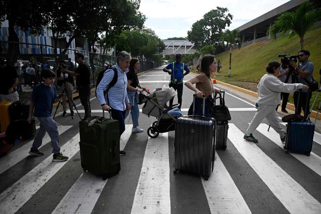 Passengers arrive to check in during the reopening of Simon Bolivar International Airport, which was damaged by twin earthquakes in June, in Maiquetia, Venezuela, on September 1, 2026. (Photo by Federico PARRA / AFP)