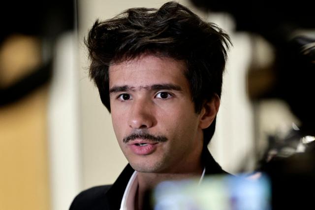 (FILES) French-Spanish lawyer Juan Branco speaks to the press during a break in the trial of ten persons accused of sexist cyber-harassment of the wife of the French President, in Paris, on October 28, 2025. The Paris public prosecutor’s office requested to have lawyer Juan Branco sent on trial for rape charges sources close to the case said on September 1, 2026. In its final submissions issued on August 6, the Paris public prosecutor’s office is requesting that Juan Branco, 37, be on trial for a rape committed against a young woman in the spring of 2021. It is seeking that the charges be dropped for other acts of sexual assault and rape involving two other women, for which the lawyer is also being prosecuted. (Photo by STEPHANE DE SAKUTIN / AFP)