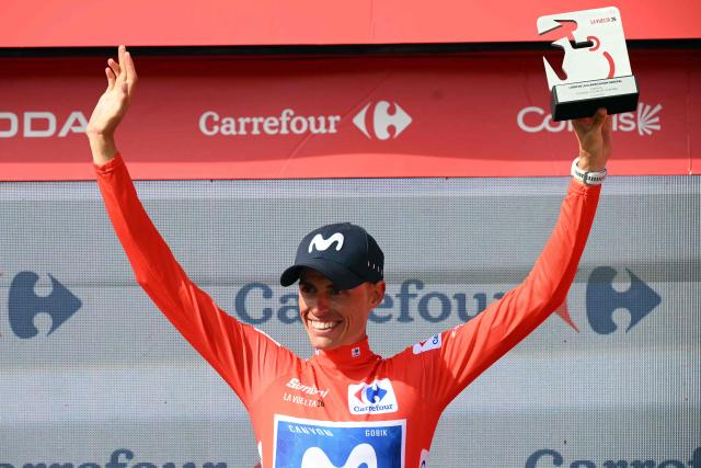Team Movistar's Spanish rider Enric Mas celebrates on the podium retaining the overall leader's red jersey after the 10th stage of the Vuelta a Espana 2026 cycling tour, a 184,7 km race between Alcaraz and Elche de la Sierra, on September 1, 2026. (Photo by JOSE JORDAN / AFP)