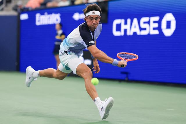 Argentina's Francisco Comesana reaches for a return against Italy's Flavio Cobolli during their men's singles first round tennis match on day three of the US Open tennis tournament at the USTA Billie Jean King National Tennis Center in New York City on September 1, 2026. (Photo by TIMOTHY A. CLARY / AFP)