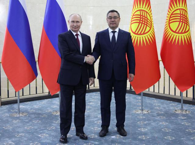 In this pool photograph distributed by the Russian state agency Sputnik, Russia's President Vladimir Putin and Kyrgyzstan's President Sadyr Japarov hold a meeting on the sidelines of the Shanghai Cooperation Organisation (SCO) summit in Bishkek on September 1, 2026. (Photo by Peter KOVALEV / POOL / AFP)