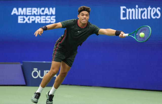 USA's Darwin Blanch reaches to play a return to USA's Taylor Fritz during their men's singles first round tennis match on day three of the US Open tennis tournament at the USTA Billie Jean King National Tennis Center in New York City on September 1, 2026. (Photo by KENA BETANCUR / AFP)