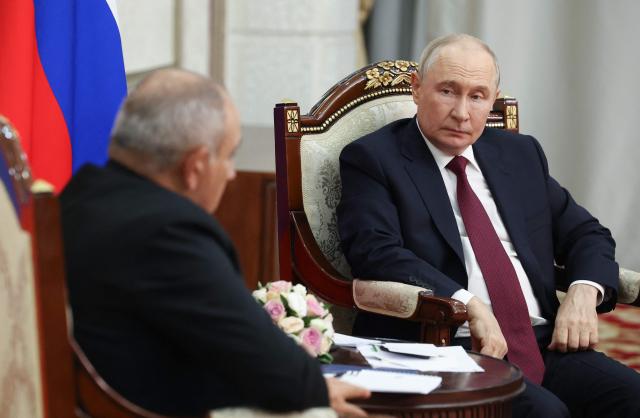 In this pool photograph distributed by the Russian state agency Sputnik, Russia's President Vladimir Putin and Armenian Prime Minister Nikol Pashinyan hold a meeting on the sidelines of the Shanghai Cooperation Organisation (SCO) summit in Bishkek on September 1, 2026. (Photo by Vyacheslav PROKOFYEV / POOL / AFP)