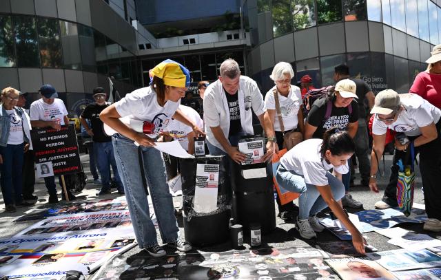 Relatives of political prisoners take part in the "How Much Oil Do Our Prisoners Cost?" march outside the Ministry of Prisons in Caracas on September 1, 2026. Relatives of political prisoners demonstrate in Caracas on September 1, calling on Washington over the failure to secure the release of their detained loved ones, as a major oil agreement between the United States and Venezuela takes shape. (Photo by Juan BARRETO / AFP)