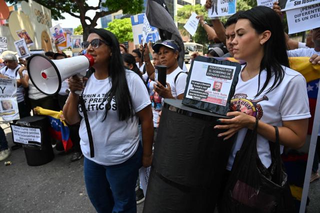 Relatives of political prisoners take part in the "How Much Oil Do Our Prisoners Cost?" march outside the Ministry of Prisons in Caracas on September 1, 2026. Relatives of political prisoners demonstrate in Caracas on September 1, calling on Washington over the failure to secure the release of their detained loved ones, as a major oil agreement between the United States and Venezuela takes shape. (Photo by Juan BARRETO / AFP)