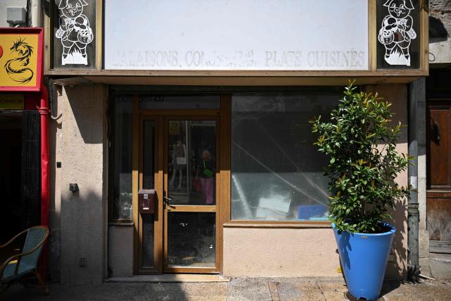 This photograph shows the storefront of a closed business in Saint-Gaudens, where commercial vacancy has increased over the past ten years on July 29, 2026. 'For sale', 'to let', 'potential to convert into a home': the streets of Saint-Gaudens' old town are dotted with closed-down commercial premises, whilst this town of just over 12,000 inhabitants at the foot of the Pyrenees fears losing its paper pulp mill and the hundreds of jobs it provides. "Watchmaker and jeweller", "quick alterations", "hairdresser", "optician"  these are the signs visible on some of the abandoned shop fronts, giving a clue as to what sort of business once occupied the premises. In other cases, there is no trace left of the former business. Some shop windows are even completely covered by posters of all kinds, including some dating back several years, such as one calling for a protest against the 2023 pension reforms. (Photo by Lionel BONAVENTURE / AFP)