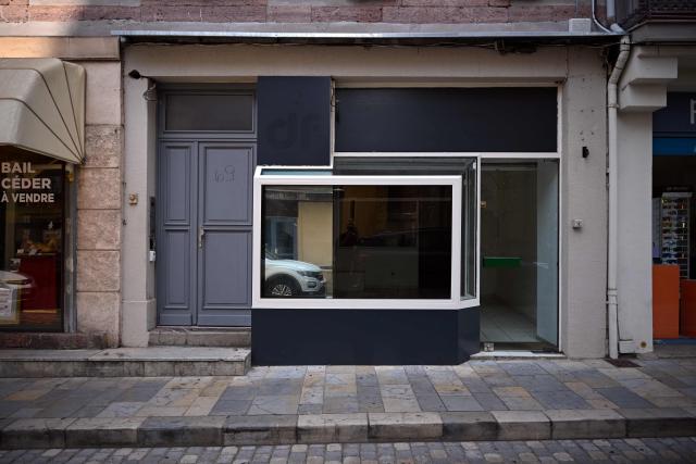 This photograph shows the storefront of a closed business in Saint-Gaudens, where commercial vacancy has increased over the past ten years on July 29, 2026. 'For sale', 'to let', 'potential to convert into a home': the streets of Saint-Gaudens' old town are dotted with closed-down commercial premises, whilst this town of just over 12,000 inhabitants at the foot of the Pyrenees fears losing its paper pulp mill and the hundreds of jobs it provides. "Watchmaker and jeweller", "quick alterations", "hairdresser", "optician"  these are the signs visible on some of the abandoned shop fronts, giving a clue as to what sort of business once occupied the premises. In other cases, there is no trace left of the former business. Some shop windows are even completely covered by posters of all kinds, including some dating back several years, such as one calling for a protest against the 2023 pension reforms. (Photo by Lionel BONAVENTURE / AFP)