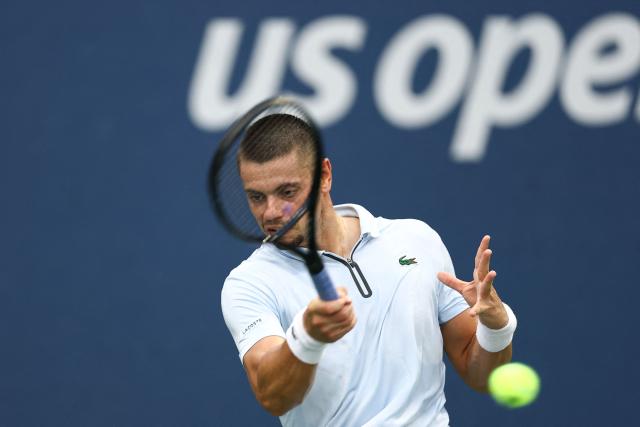 France's Arthur Gea hits a return to Argentina's Juan Manuel Cerundolo during their men's singles first round tennis match on day three of the US Open tennis tournament at the USTA Billie Jean King National Tennis Center in New York on September 1, 2026. (Photo by CHARLY TRIBALLEAU / AFP)