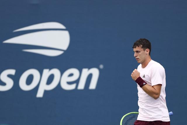 Argentina's Juan Manuel Cerundolo reacts as he plays France's Arthur Gea in their men's singles first round tennis match on day three of the US Open tennis tournament at the USTA Billie Jean King National Tennis Center in New York on September 1, 2026. (Photo by CHARLY TRIBALLEAU / AFP)