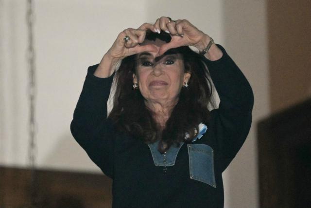 Former Argentine President and Vice President Cristina Fernandez de Kirchner gestures to supporters from the balcony of her house arrest in Buenos Aires on September 1, 2026, during the fourth anniversary of the failed assassination attempt against her. (Photo by JUAN MABROMATA / AFP)