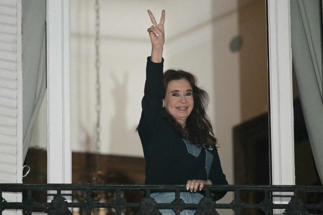 Former Argentine President and Vice President Cristina Fernandez de Kirchner gestures to supporters from the balcony of her house arrest in Buenos Aires on September 1, 2026, during the fourth anniversary of the failed assassination attempt against her. (Photo by JUAN MABROMATA / AFP)