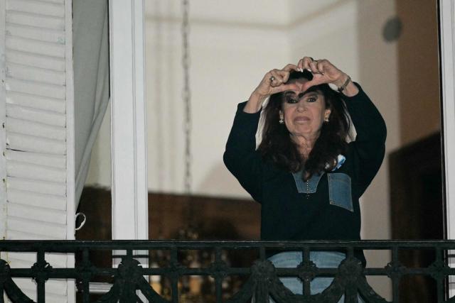 Former Argentine President and Vice President Cristina Fernandez de Kirchner gestures to supporters from the balcony of her house arrest in Buenos Aires on September 1, 2026, during the fourth anniversary of the failed assassination attempt against her. (Photo by JUAN MABROMATA / AFP)