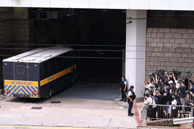 A prison van (L) purported to be holding pro-democracy activist Joshua Wong arrives at the High Court in Hong Kong on September 2, 2026. Prominent Hong Kong pro-democracy activist Wong is expected to plead guilty on September 2 at the court in a national security trial accusing him of foreign collusion. (Photo by Peter PARKS / AFP)