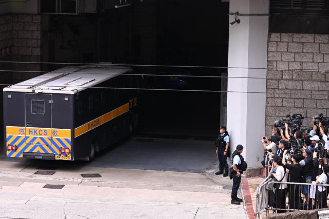 A prison van (L) purported to be holding pro-democracy activist Joshua Wong arrives at the High Court in Hong Kong on September 2, 2026. Prominent Hong Kong pro-democracy activist Wong is expected to plead guilty on September 2 at the court in a national security trial accusing him of foreign collusion. (Photo by Peter PARKS / AFP)