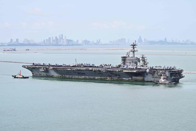 US nuclear-powered aircraft carrier USS Abraham Lincoln (CVN-72) is seen near Laem Chabang Port, in the Gulf of Thailand on September 2, 2026, near the city of Pattaya (back). (Photo by ANTHONY WALLACE / AFP)