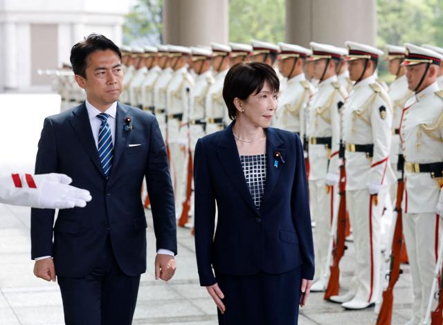 Japan's Prime Minister Sanae Takaichi and Defence Minister Shinjiro Koizumi inspect an honour guard at the Self-Defense Forces Senior Commanders' Conference in Tokyo on September 2, 2026. (Photo by Kim Kyung-Hoon / POOL / AFP)
