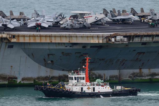 A tugboat guides US nuclear-powered aircraft carrier USS Abraham Lincoln (CVN-72) towards Laem Chabang Port, near the city of Pattaya on September 2, 2026. (Photo by ANTHONY WALLACE / AFP)