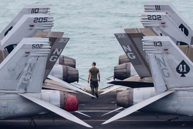 A crew member walks on the flight deck of US nuclear-powered aircraft carrier USS Abraham Lincoln (CVN-72) as it heads towards Laem Chabang Port, near the city of Pattaya on September 2, 2026. (Photo by ANTHONY WALLACE / AFP)