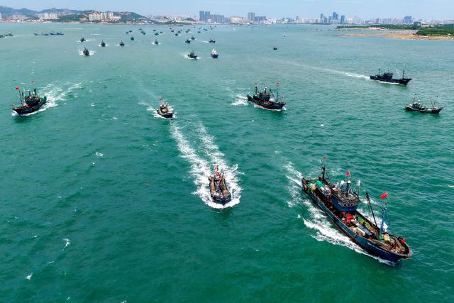 An areal view shows fishing boats sailing out to sea from Jimiya Fishing Port in Qingdao West Coast New Area, in eastern China's Shandong province, on September 1, 2026, as the autumn fishing season begins following a four-month summer moratorium. (Photo by CN-STR / AFP) / China OUT